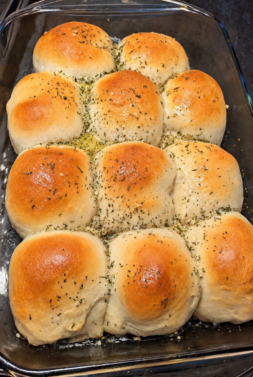 Garlic herb pull-apart buns in a glass baking dish